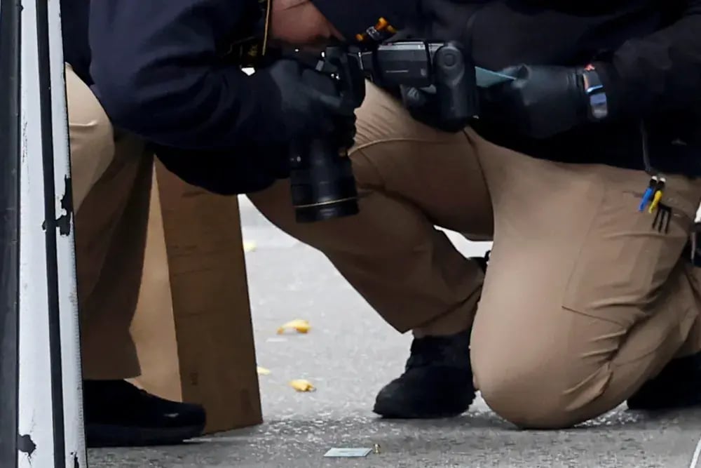 Photographers taking a close ups of something on the floor