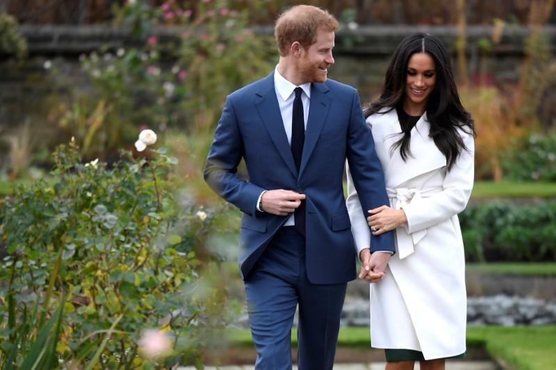 Britain's Prince Harry poses with Meghan Markle in the Sunken Garden of Kensington Palace, London, Britain, November 27, 2017. REUTERS/Toby Melville