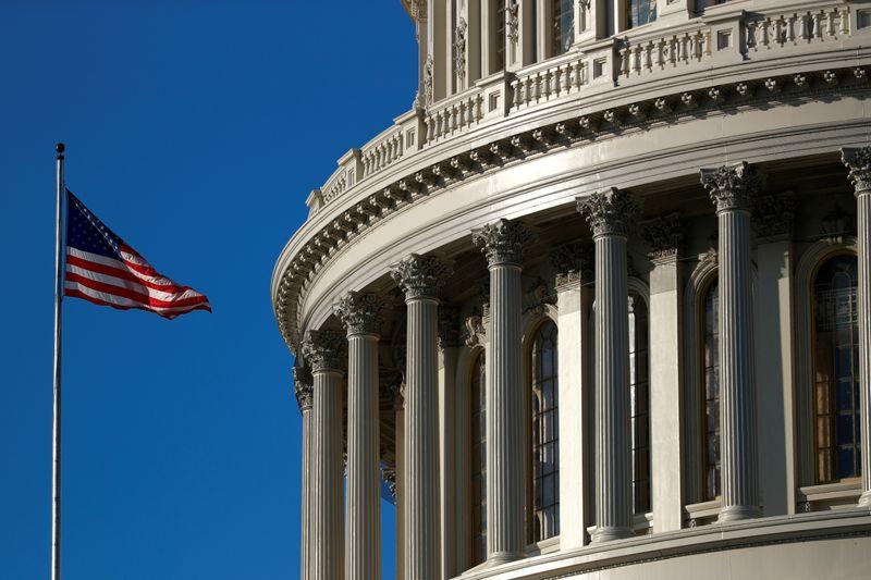 An American flag flies outside of the U.S. Capitol dome in Washington, U.S., January 15, 2020. REUTERS/Tom Brenner/File Photo 