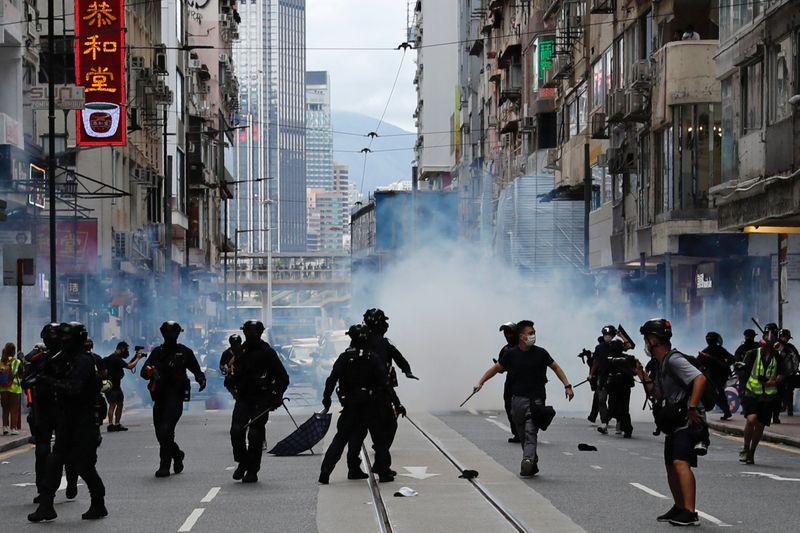 Riot police fire tear gas into the crowds to disperse anti-national security law protesters during a march at the anniversary of Hong Kong's handover to China from Britain in Hong Kong, China July 1, 2020. REUTERS/Tyrone Siu