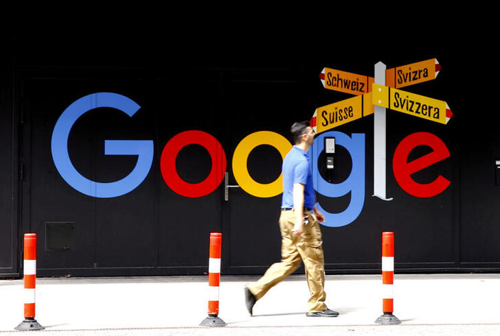 FILE PHOTO: A man walks past a logo of Google in front of at an office building in Zurich, Switzerland July 1, 2020.   REUTERS/Arnd Wiegmann/File Photo