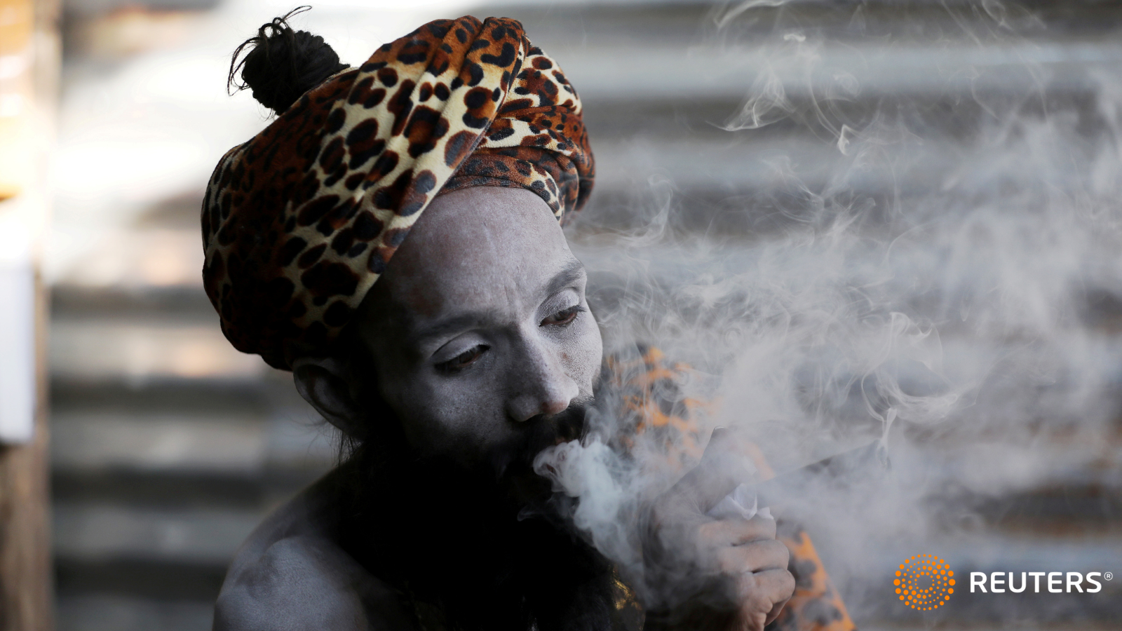 A Sadhu or Hindu holy man smokes inside his tent ahead of the first Shahi Snan at “Kumbh Mela” or the Pitcher Festival, in Haridwar