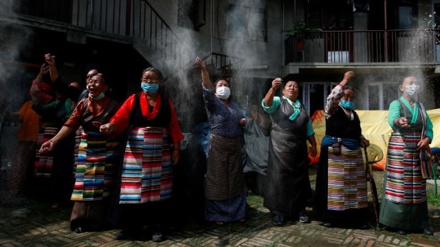 Tibetans take part in a function organised to mark the 86th birthday celebration of Dalai Lama in Lalitpur