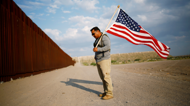 Military veterans walk on the border between the U.S. and Mexico to request their return to the United States, in Sunland Park