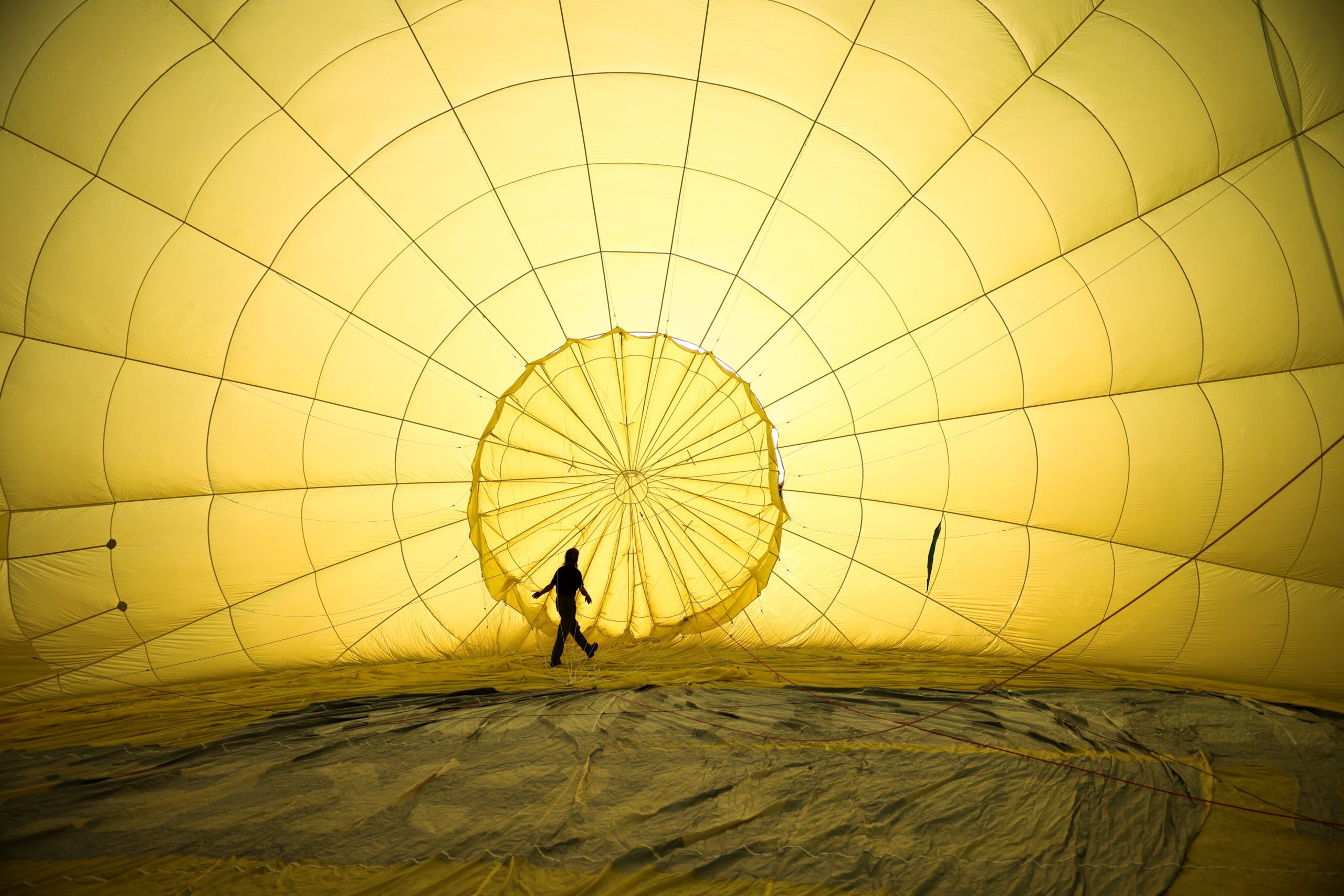 A crew member inspects a partially inflated hot air balloon at the Bristol International Balloon Fiesta in Bristol, Britain, August 4, 2021. REUTERS/Henry Nicholls - RC26YO9UJTHM