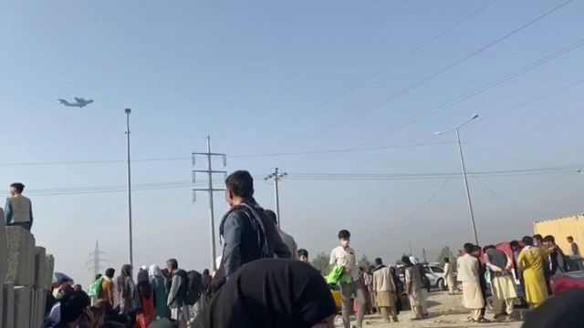 Afghans continue wait outside Kabul airport, gunshots heard