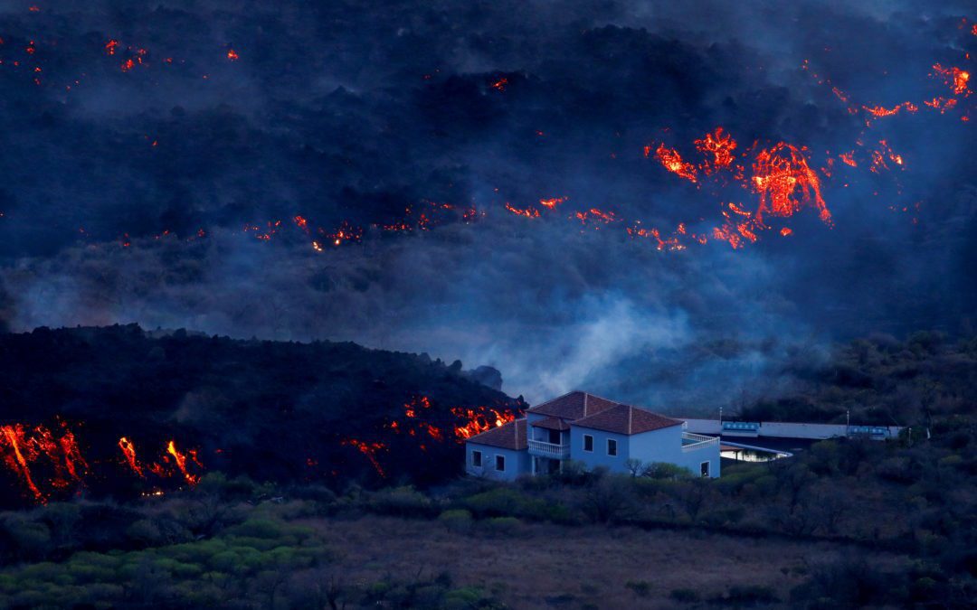 A house is photographed in Tajuya next to the lava of the Cumbre Vieja volcano that continues to erupt