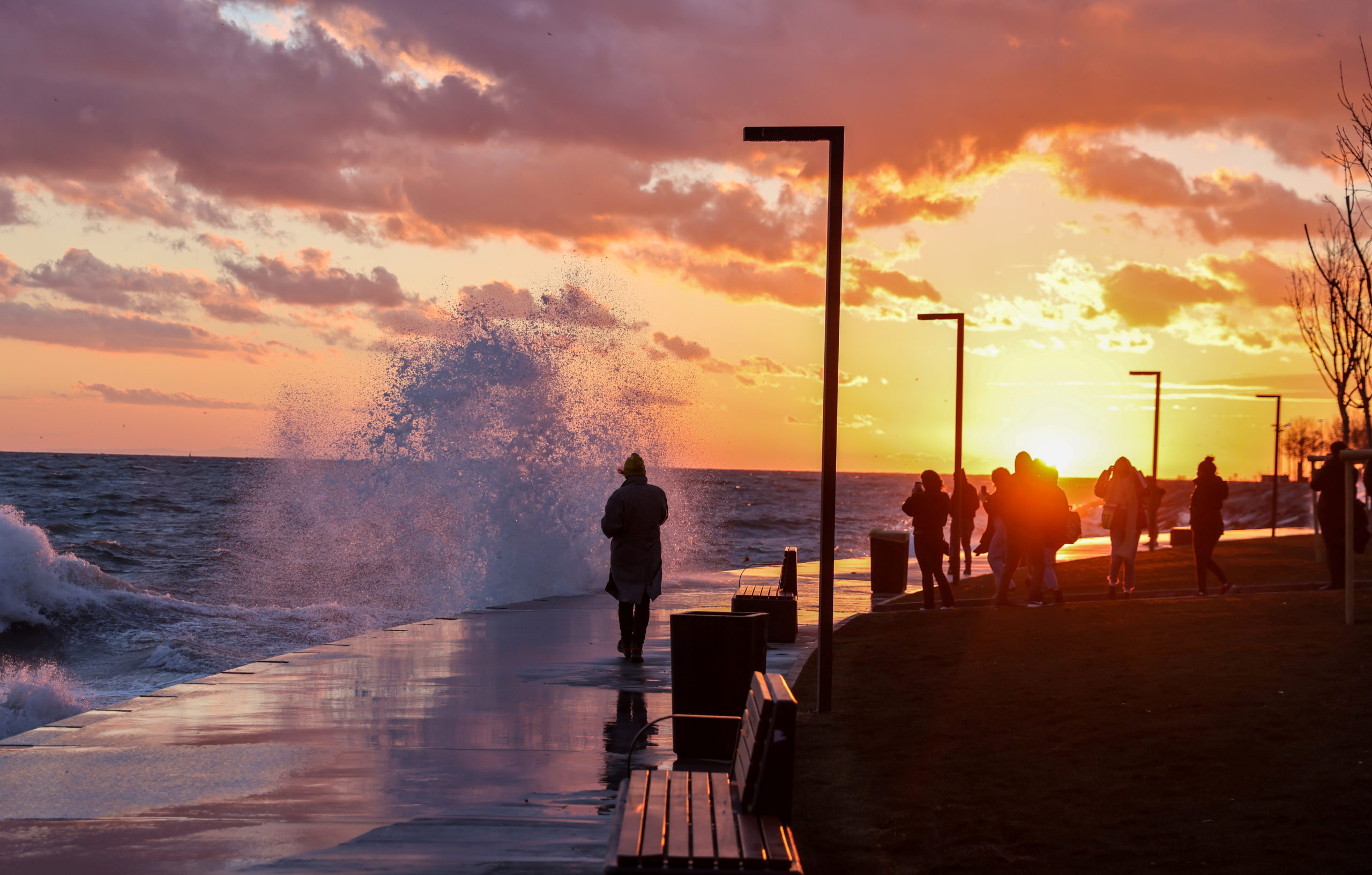 People enjoy a sunset during a windy day in Istanbul