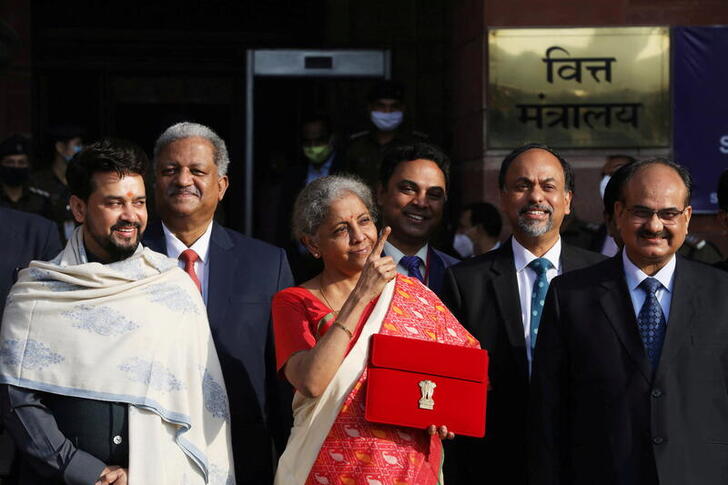 FILE PHOTO: India's Finance Minister Nirmala Sitharaman stands next to Minister of State for Finance and Corporate Affairs Anurag Thakur (L) as she leaves her office to present the federal budget in the parliament in New Delhi, India, February 1, 2021. REUTERS/Anushree Fadnavis/File Photo