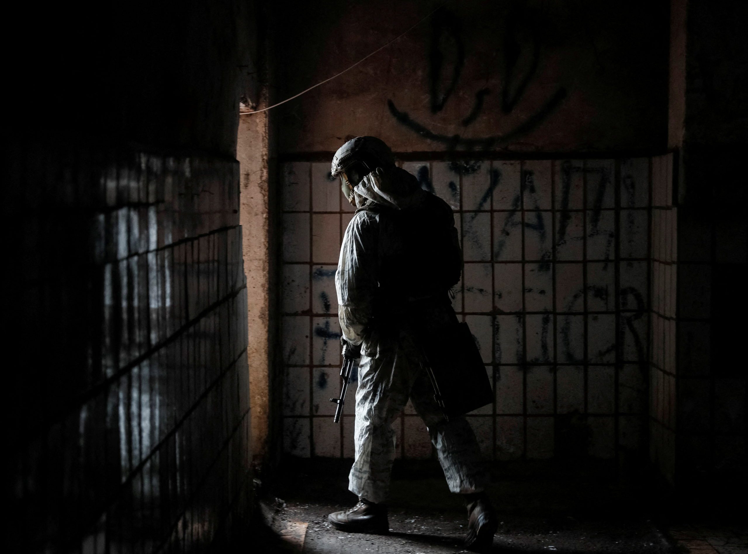 A Ukrainian service member walks on the front line at Avdiyivka