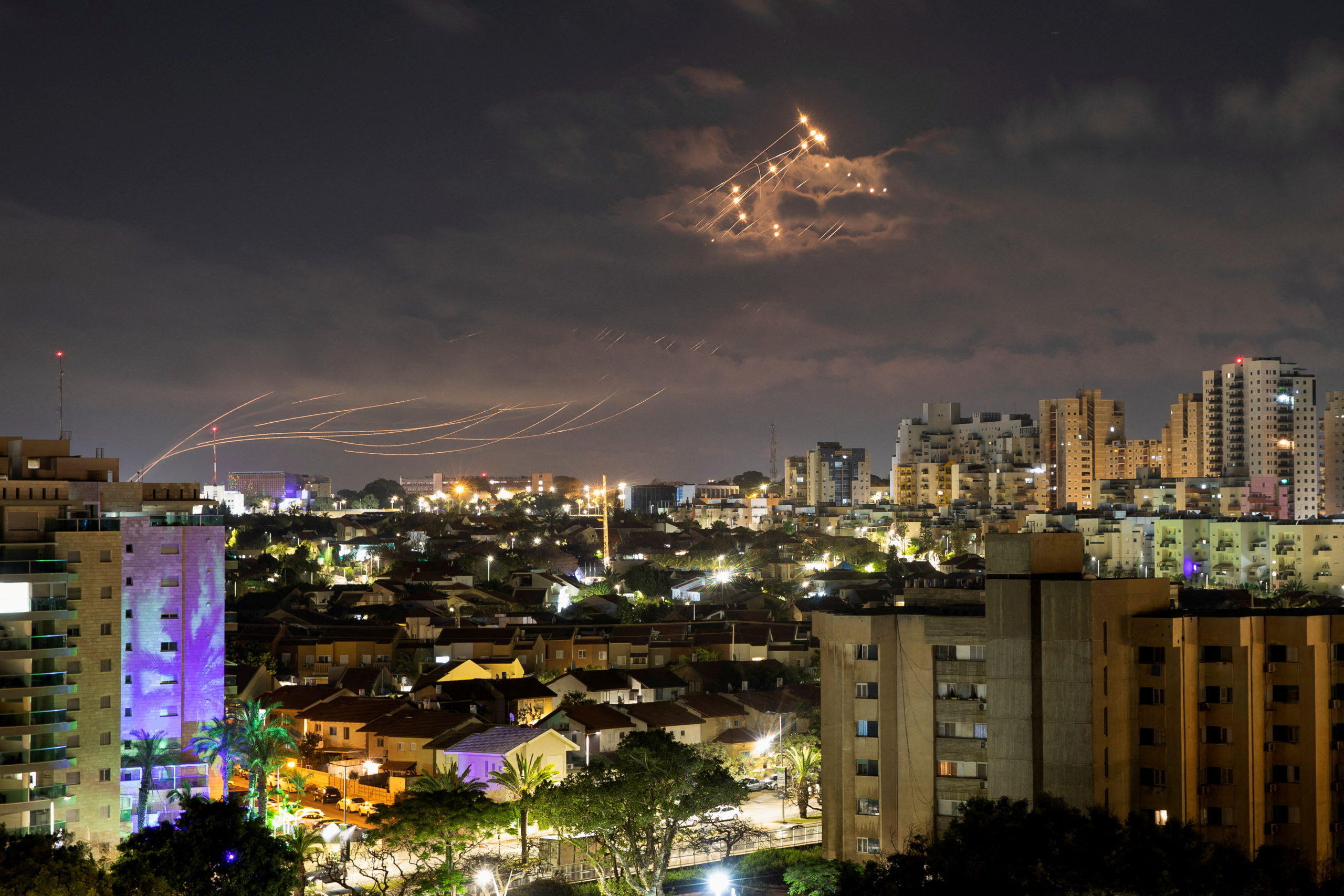 Streaks of light are seen as Israel’s Iron Dome anti-missile system intercepts rockets launched from the Gaza Strip towards Israel