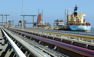 -UNDATED FILE PHOTO- An oil tanker is seen at Jose refinery cargo terminal in Venezuela in this undated file photo.[Venezuela said on April 3, 2006, it assumed control of two oil fields operated by Total of France and Italy's Eni and vowed to win any international legal claims triggered by the takeovers. The move came after the two companies failed to reach an agreement with the government to transfer their operating contracts to new joint ventures or 