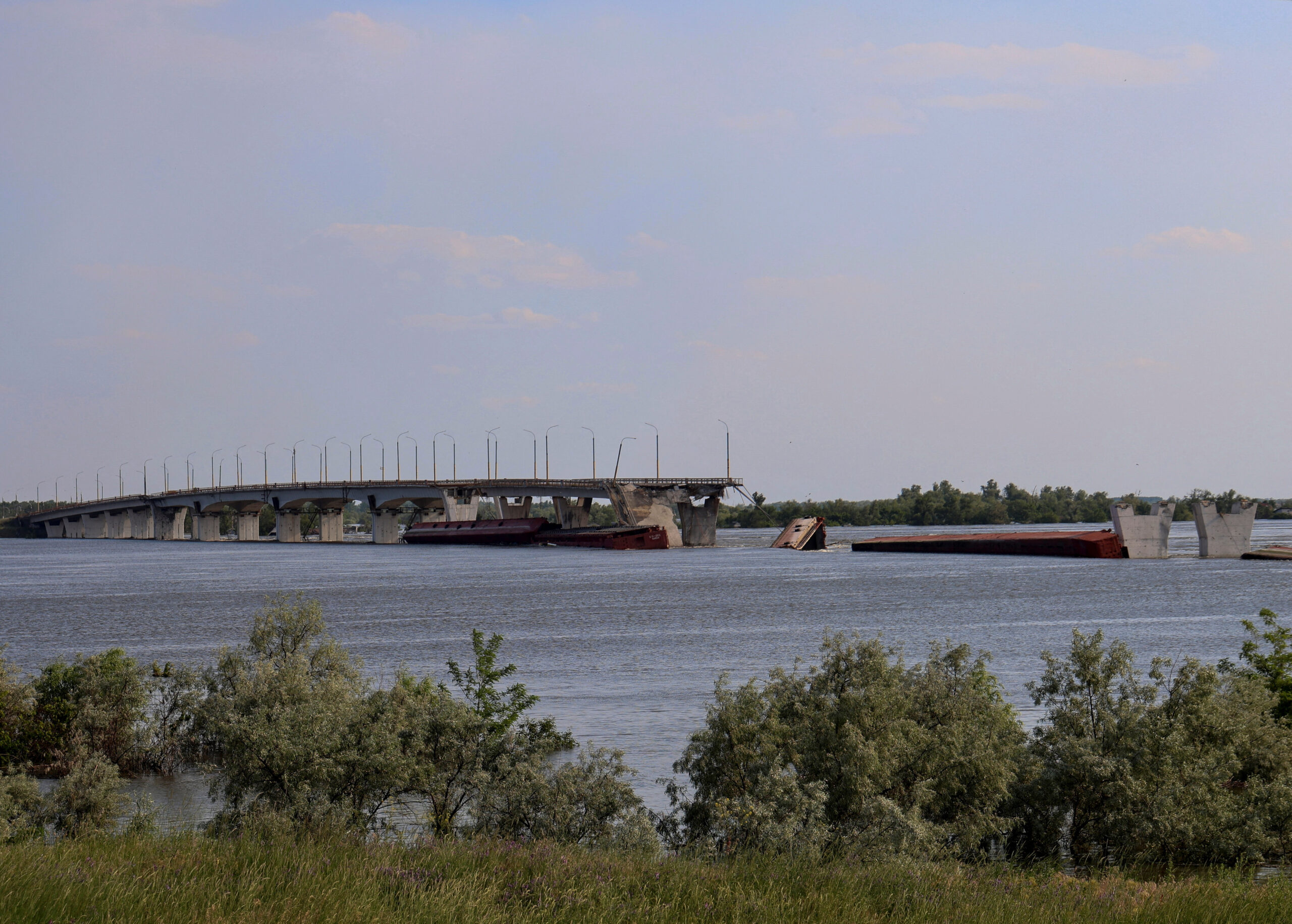 Destroyed Antonivskyi bridge is seen over the flooded Dnipro river after the Nova Kakhovka dam breached, amid Russia's attack on Ukraine, near Kherson, Ukraine June 8, 2023. REUTERS/Stringer