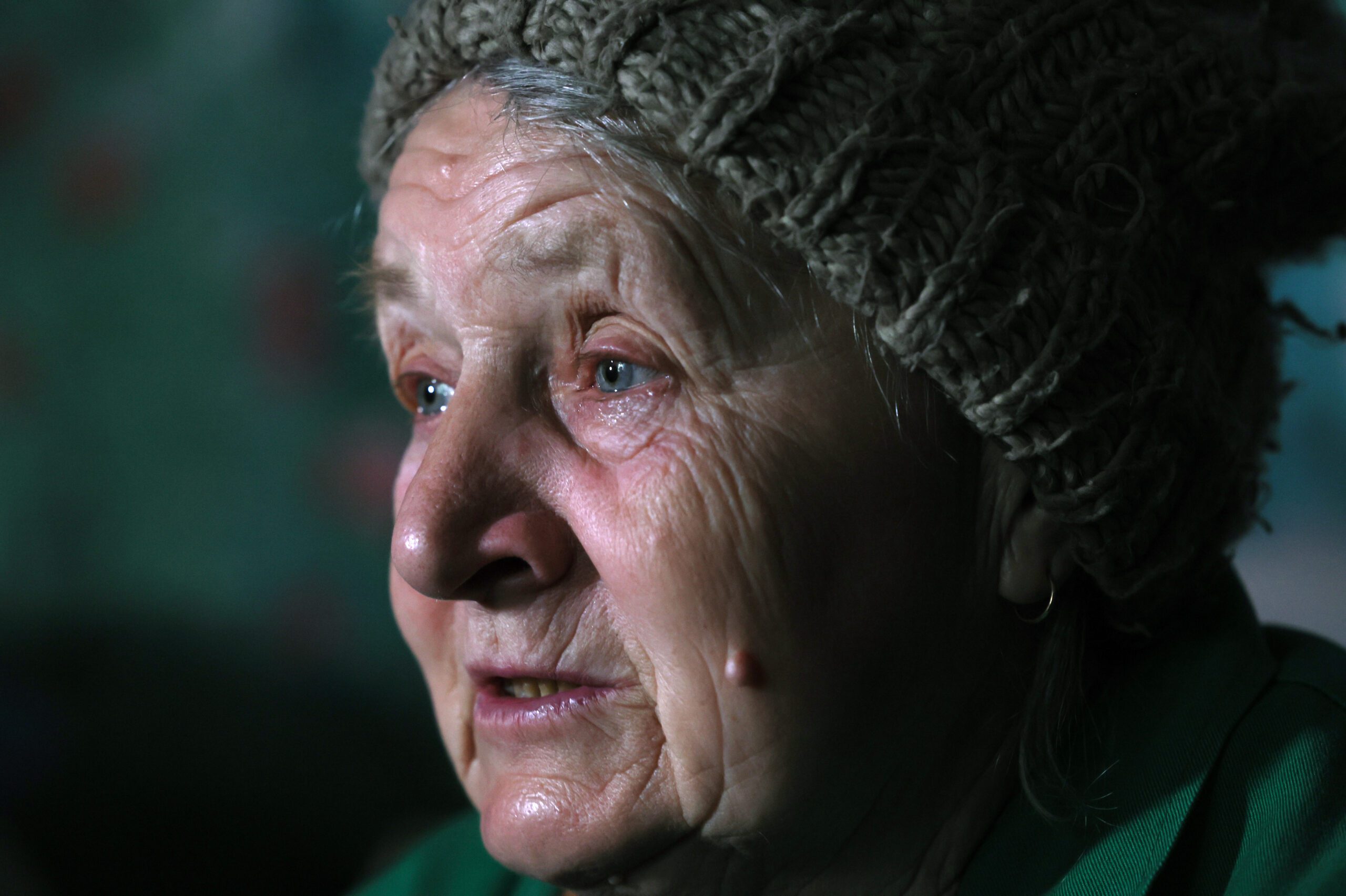 Lyubov Vasilivna, 71, reacts when listing economic vulnerability, old age, her animals and the house where the 71 year old was born as the reasons to remain in her home and not evacuate from the village of Semenivka, near the frontline town of Avdiivka, in the eastern Donetsk region, Ukraine, March 28, 2023. REUTERS/Violeta Santos Moura