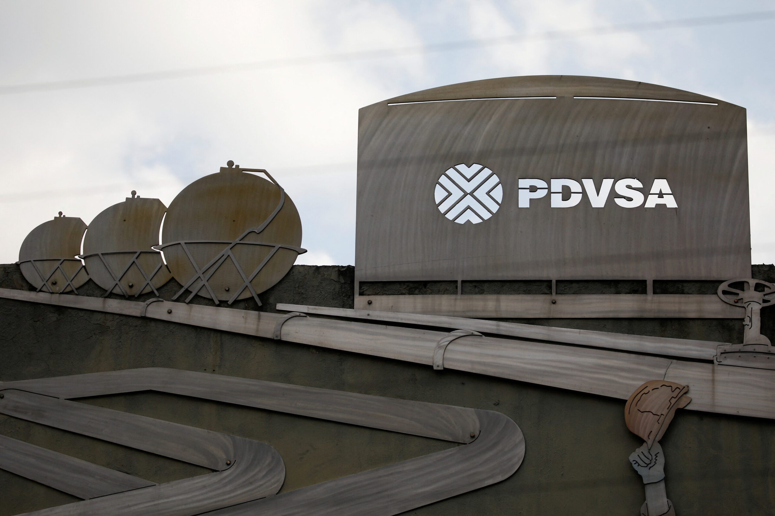 FILE PHOTO: Cutouts depicting images of oil operations are seen outside a building of Venezuela's state oil company PDVSA in Caracas, Venezuela January 28, 2019. REUTERS/Carlos Garcia Rawlins/File Photo