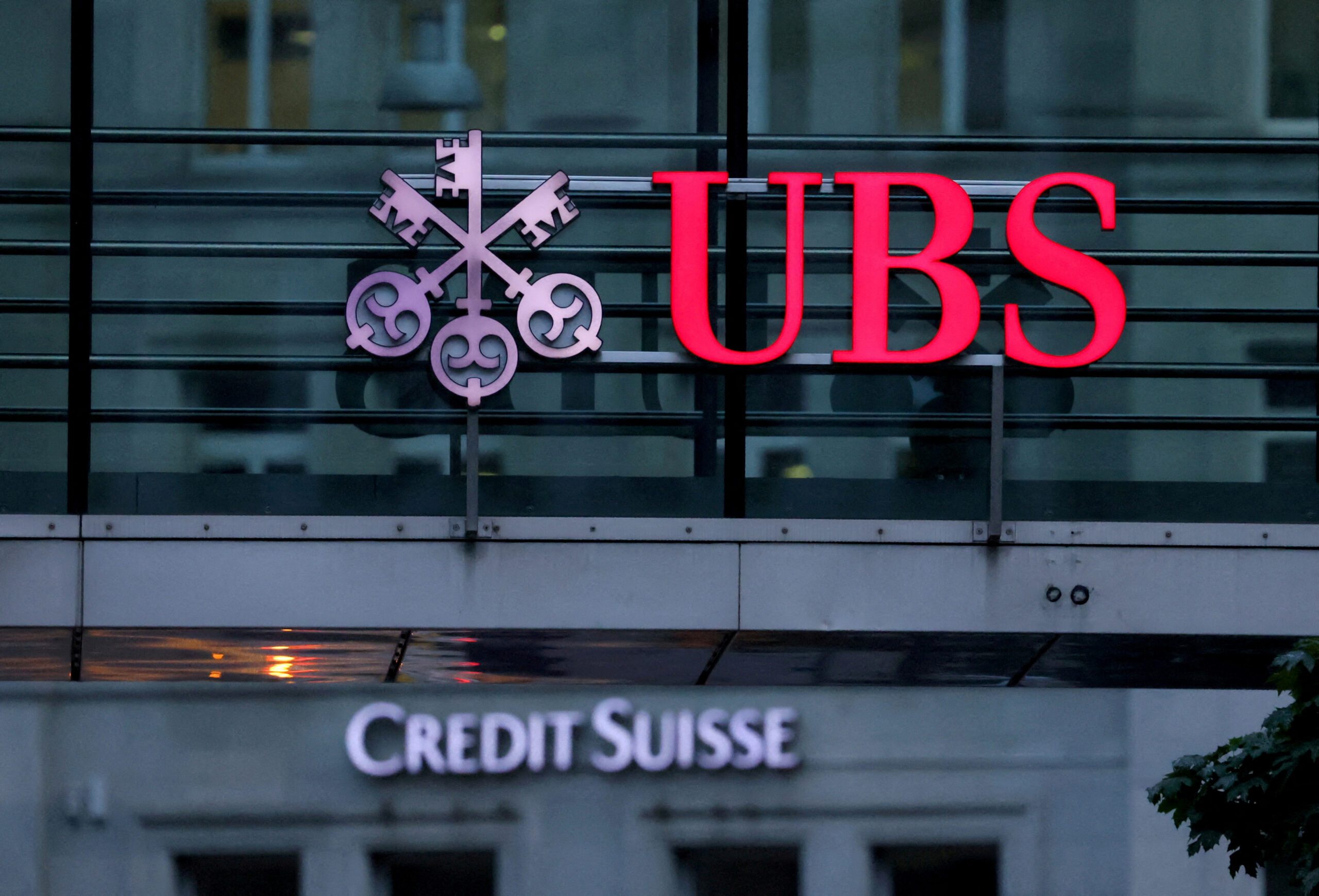 FILE PHOTO: Logos of Swiss banks Credit Suisse and UBS are seen before a news conference in Zurich Switzerland, August 30, 2023.  REUTERS/Denis Balibouse/File Photo