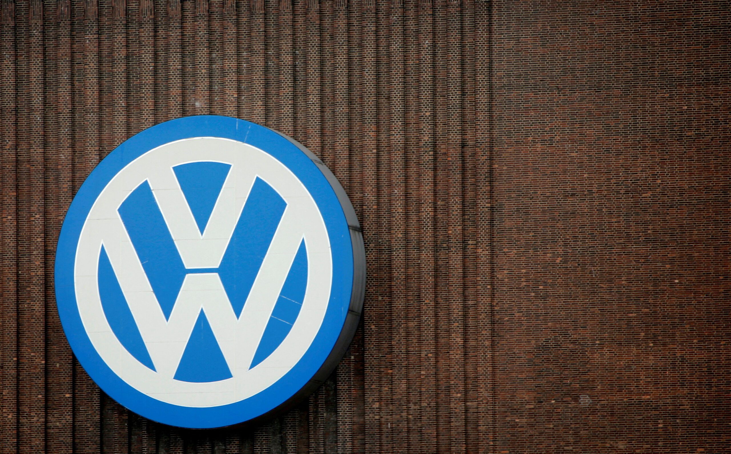 FILE PHOTO: A giant logo of Volkswagen is pictured on the wall of its production facility in Wolfsburg, Germany, April 28, 2016. REUTERS/Fabrizio Bensch/File Photo