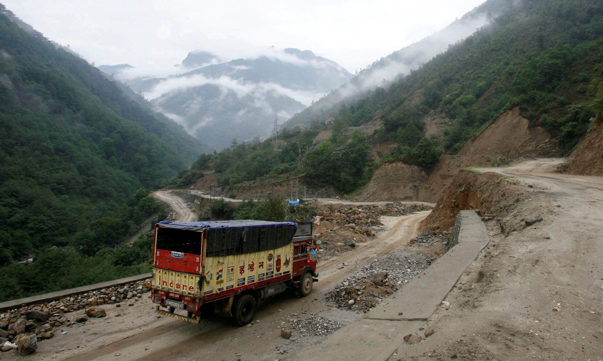 FILE PHOTO: A liquefied petroleum gas (LPG) delivery truck drives along India's Tezpur-Tawang highway which runs to the Chinese border, in the northeastern Indian state of Arunachal Pradesh May 29, 2012./File Photo