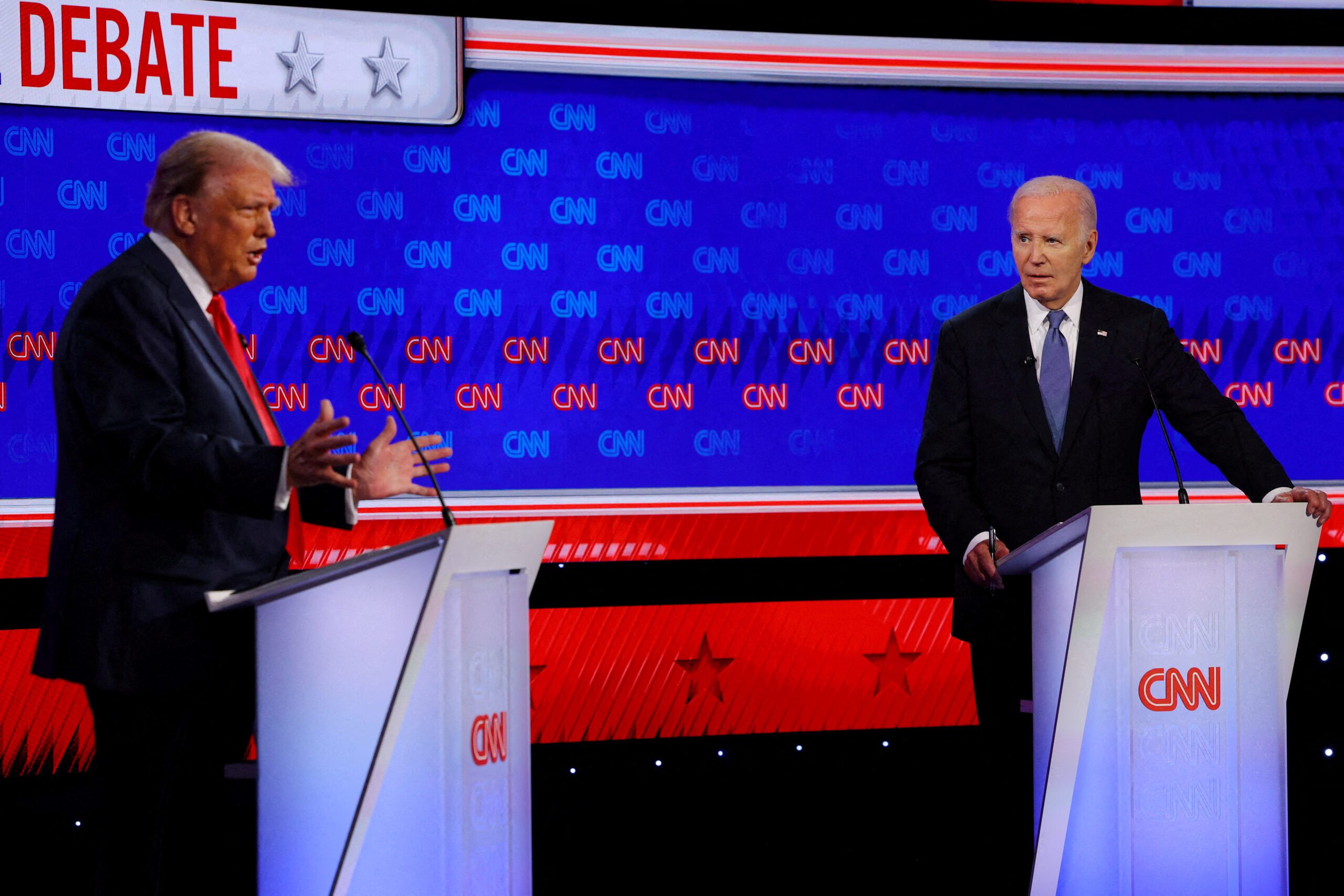 FILE PHOTO: Democrat presidential candidate U.S. President Joe Biden listens as Republican presidential candidate and former U.S. President Donald Trump speaks during their debate in Atlanta, Georgia, U.S., June 27, 2024. REUTERS/Brian Snyder/File Photo