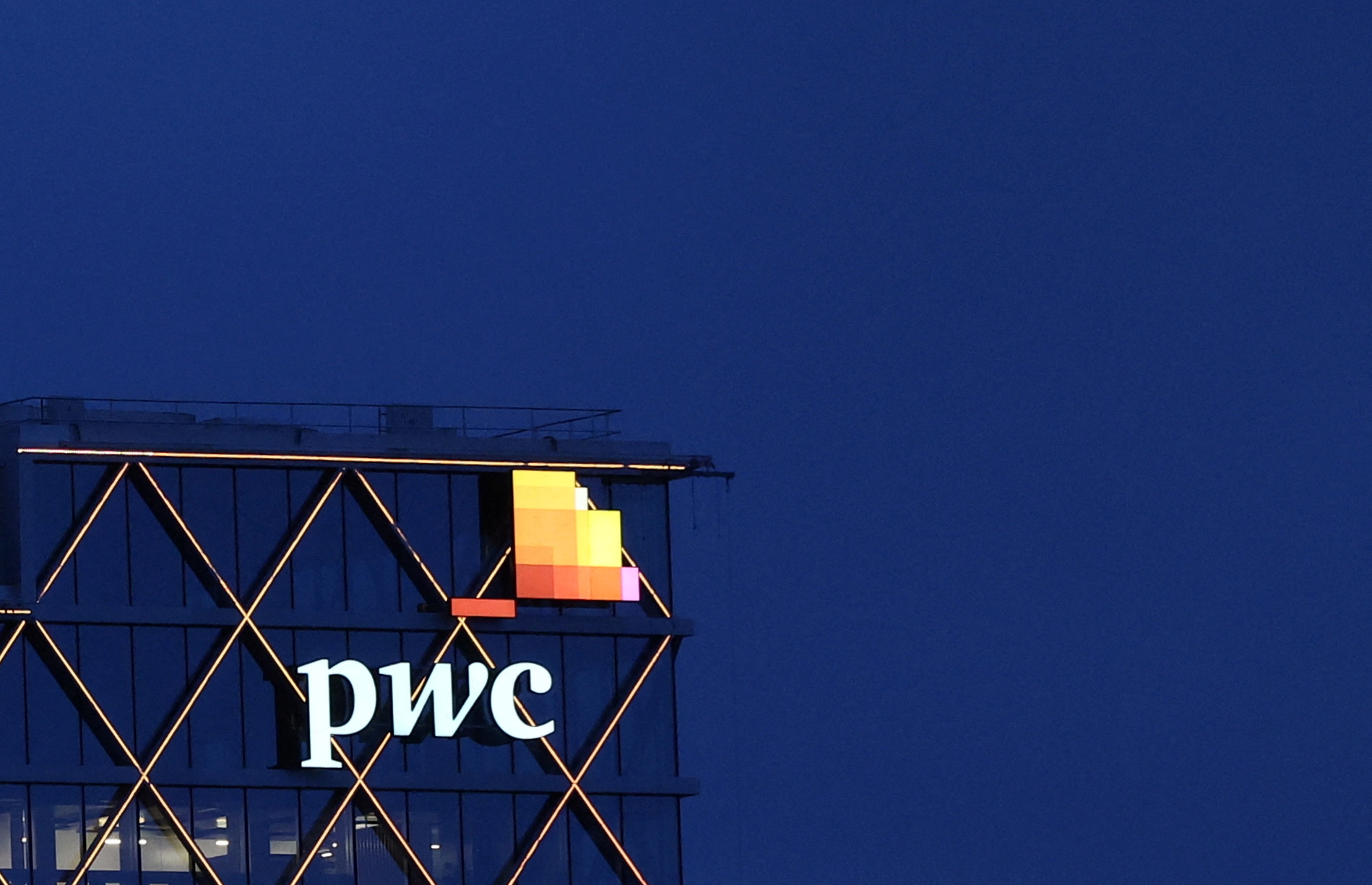 The logo of accounting firm PricewaterhouseCoopers (PwC) is seen on the top of a Brussels' office of the company, in Diegem, Belgium September 21, 2023.  REUTERS/Yves Herman