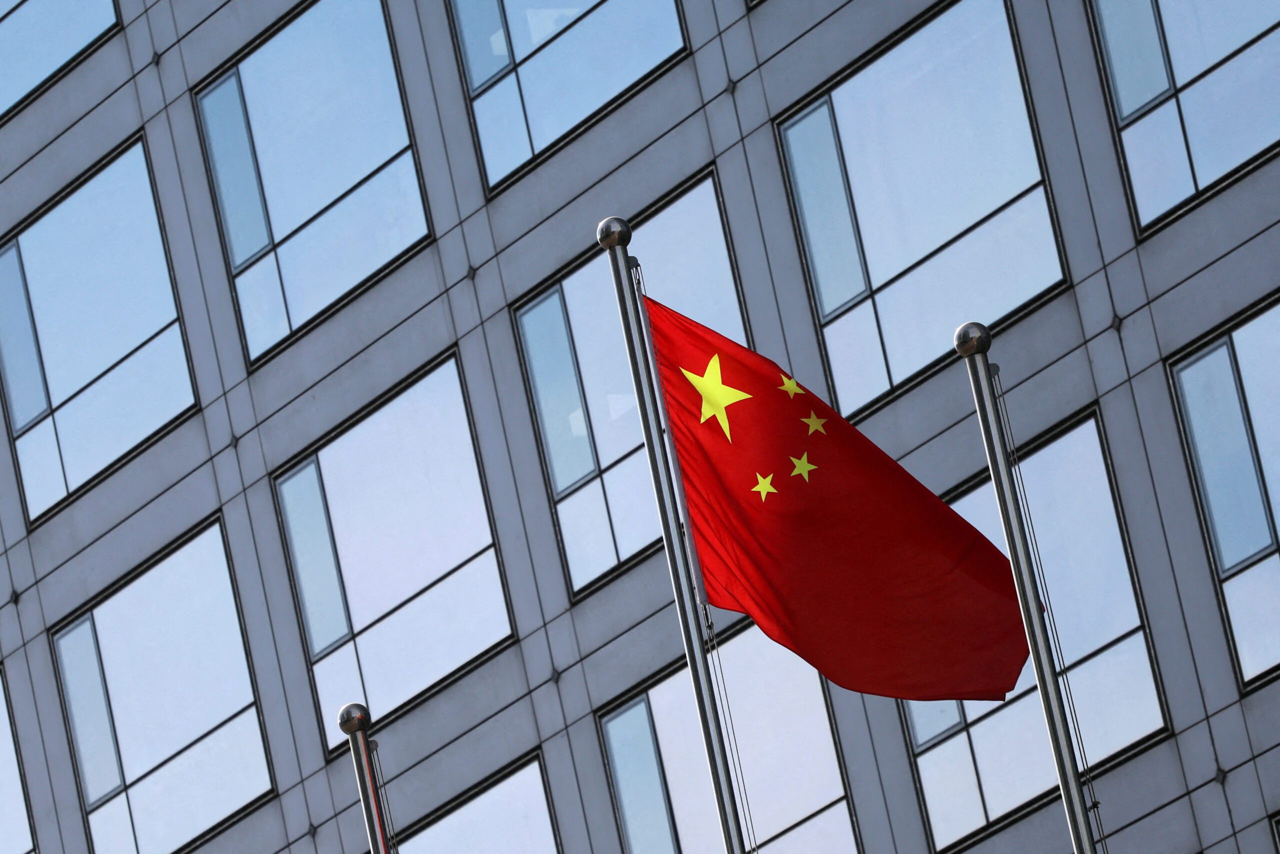 FILE PHOTO: A Chinese flag flutters outside the China Securities Regulatory Commission (CSRC) building on the Financial Street in Beijing, China February 8, 2024. REUTERS/Florence Lo/File Photo