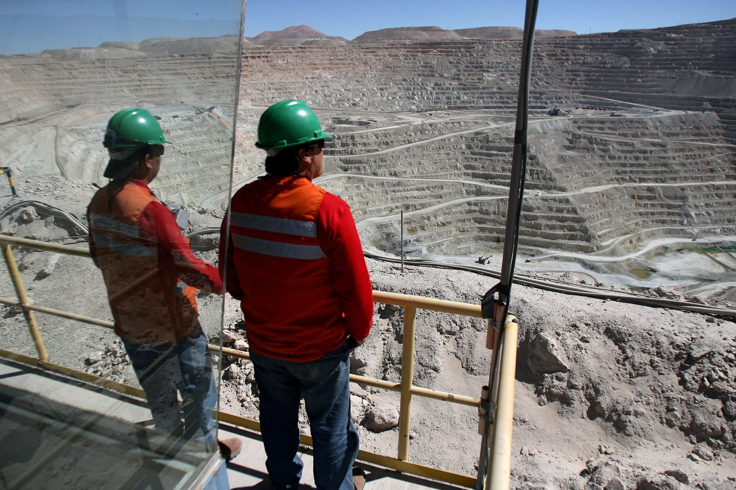 FILE PHOTO: Workers at BHP Billiton's Escondida, the world's biggest copper mine, are seen in front of the open pit, in Antofagasta, northern Chile March 31, 2008. Picture taken March 31, 2008. REUTERS/Ivan Alvarado/File Photo