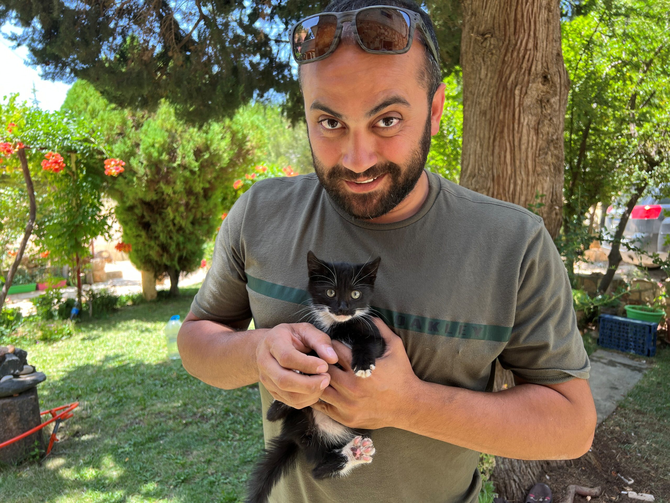 Reuters' journalist Issam Abdallah holds a kitten while posing for a picture in Saaideh, Lebanon, July 4, 2023. REUTERS/Emilie Madi - RC29W1AF6BHD