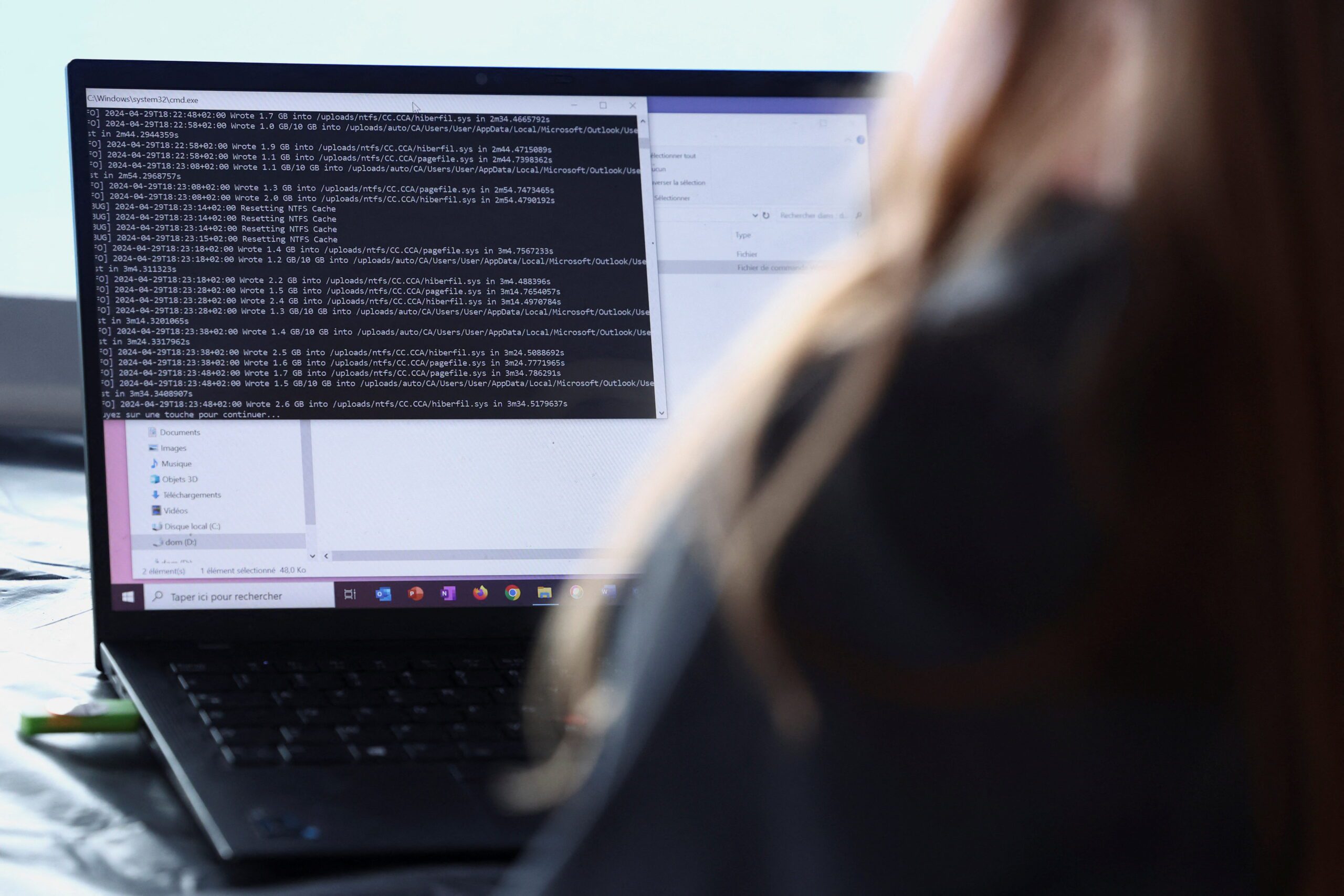 A cybersecurity employee from the Paris 2024 flying squad manages a simulated cyber attack and pretends to resolve it from a computer on the Olympic site which will host the hockey events at Yves-du-Manoir Stadium in Colombes, near Paris, France, May 3, 2024. REUTERS/Stephanie Lecocq