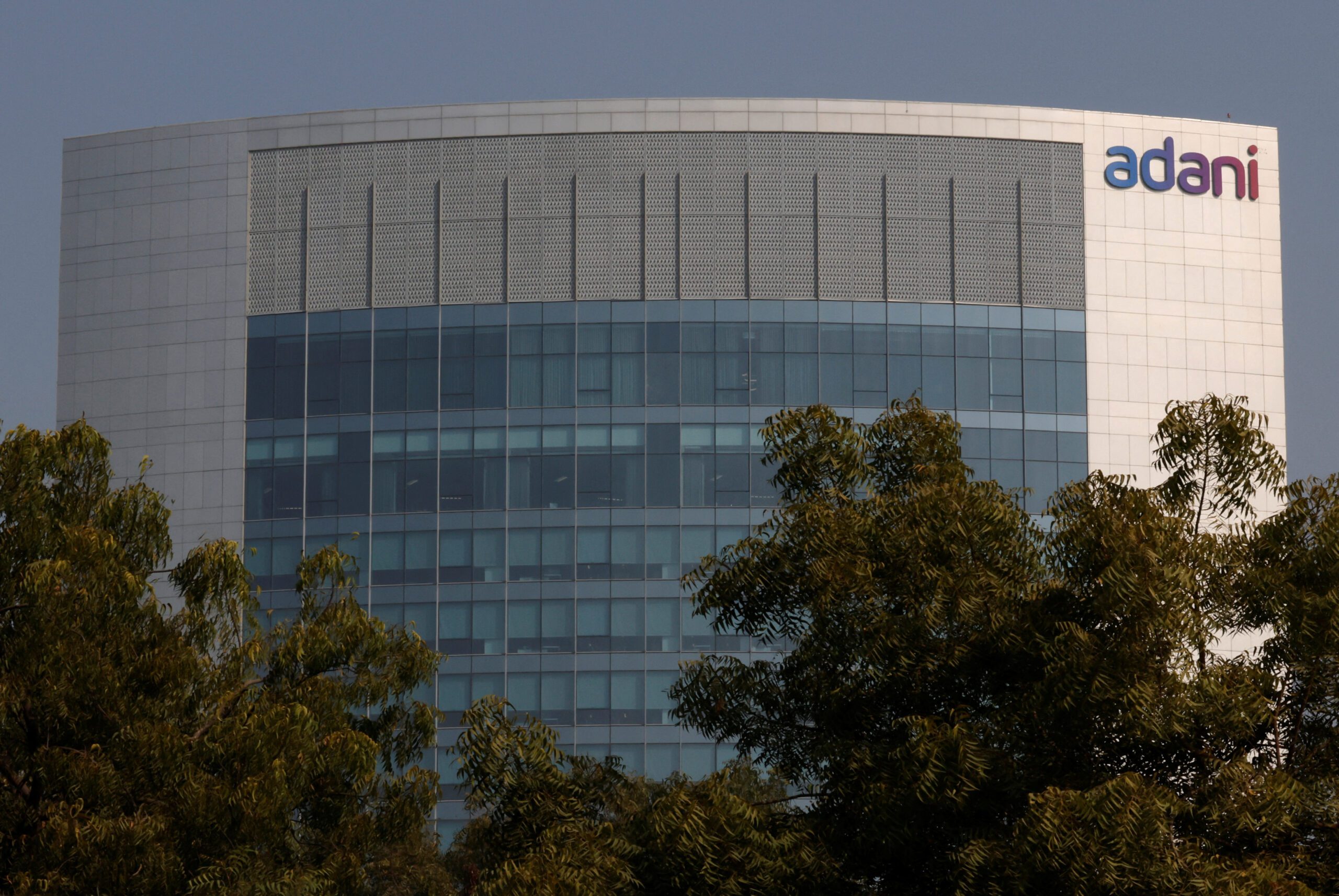 The logo of the Adani Group is seen on the facade of its Corporate House on the outskirts of Ahmedabad, India, November 22, 2024. REUTERS/Amit Dave