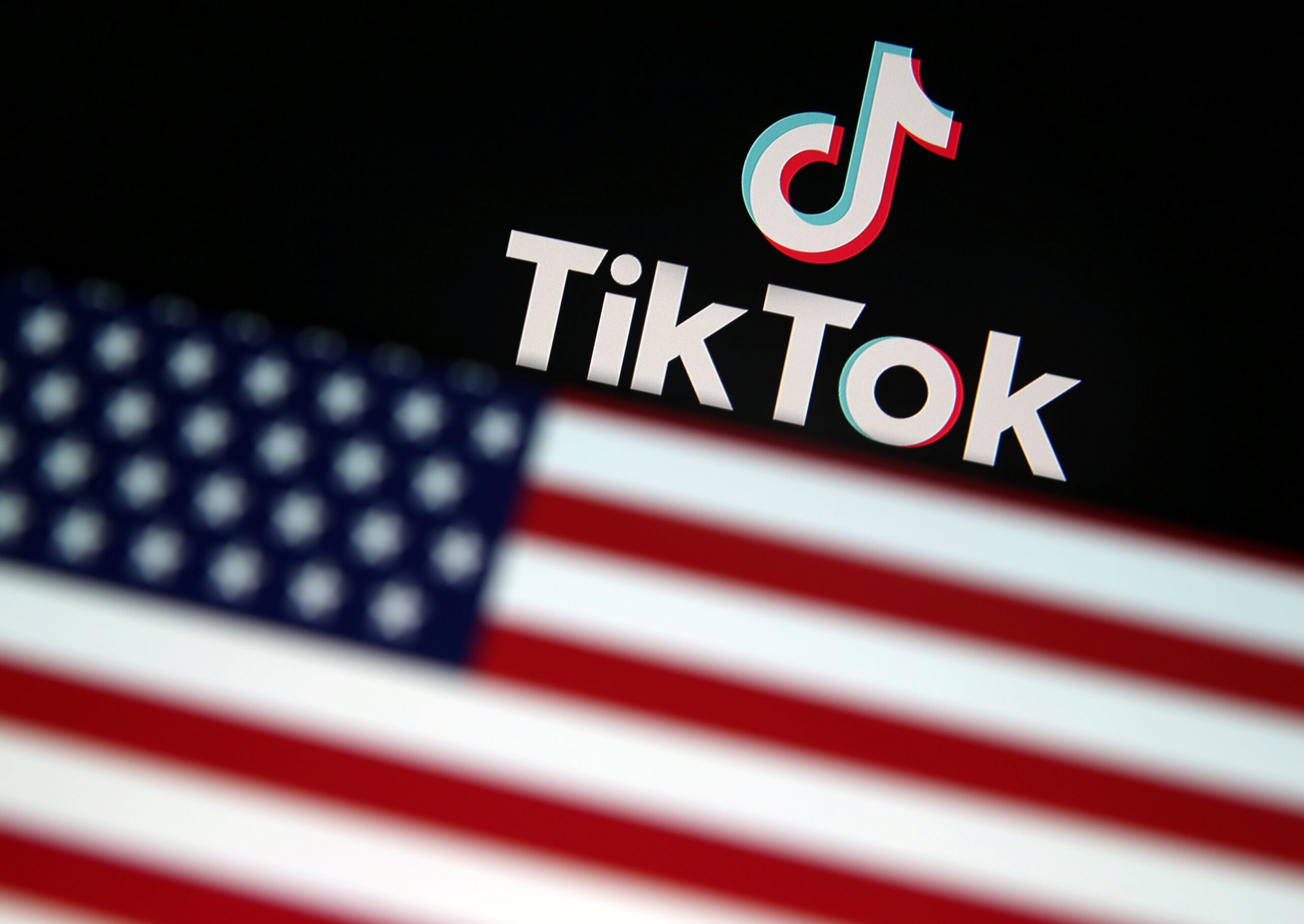 A U.S. flag is displayed in front of Tik Tok logo in this illustration picture taken August 9, 2020. REUTERS/Dado Ruvic/Illustration