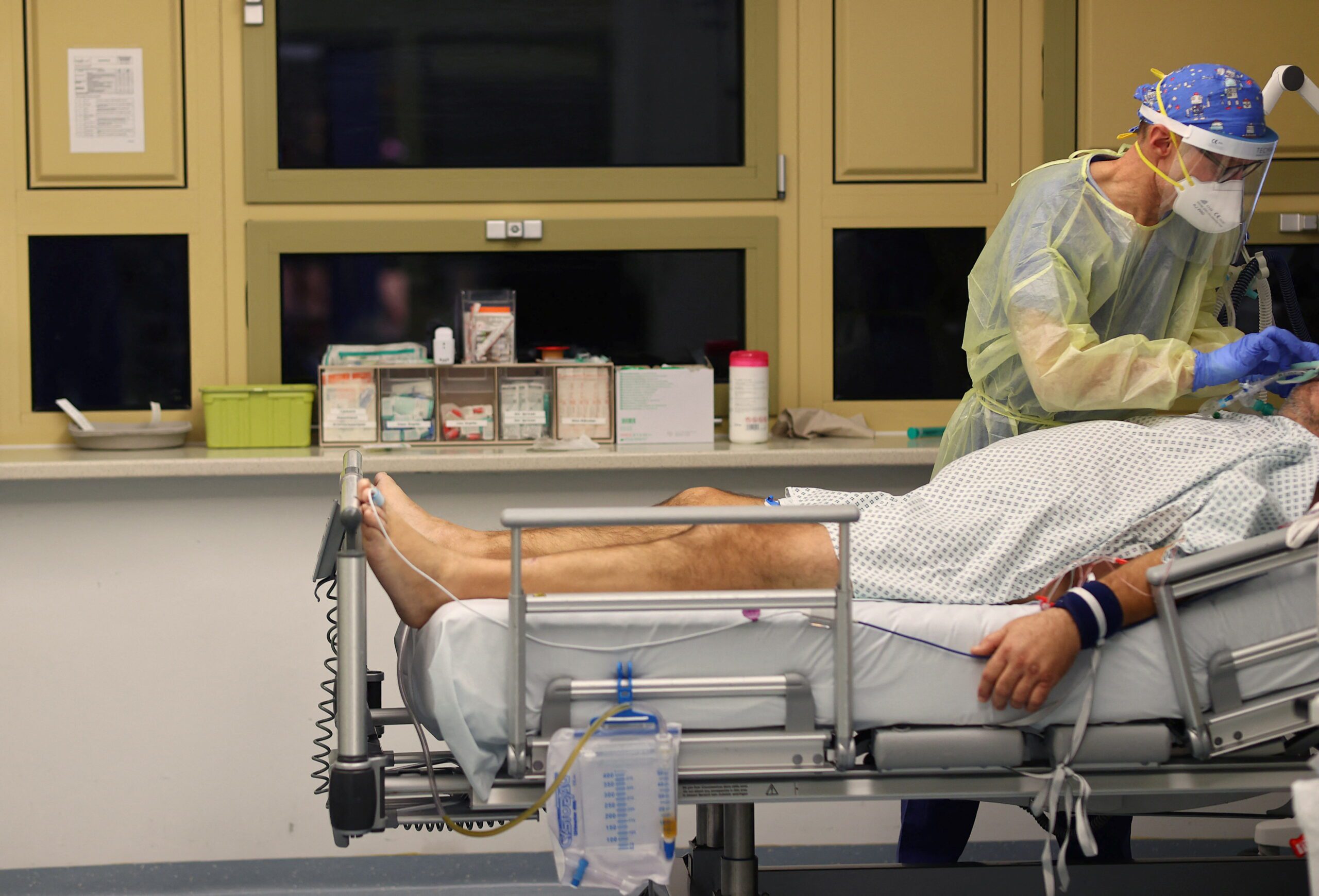 Head nurse Gunnar Goelzenleuchter looks after a patient suffering from the coronavirus disease (COVID-19) at the COVID-19 Intensive Care Unit (ICU) of the 